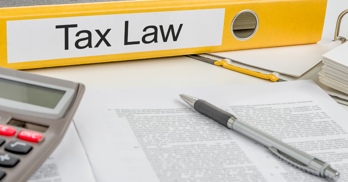 property tax law folder on desk with pen, calculator, paper
